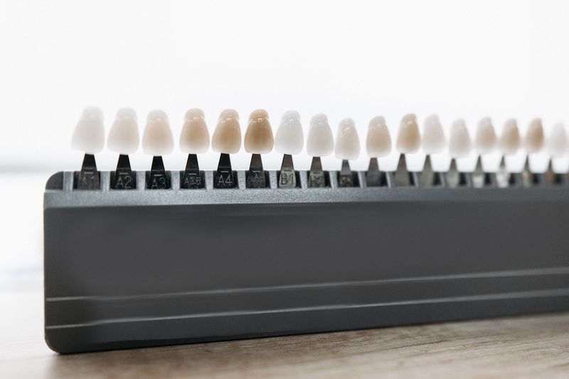 Tooth shade samples in a row on a dark holder